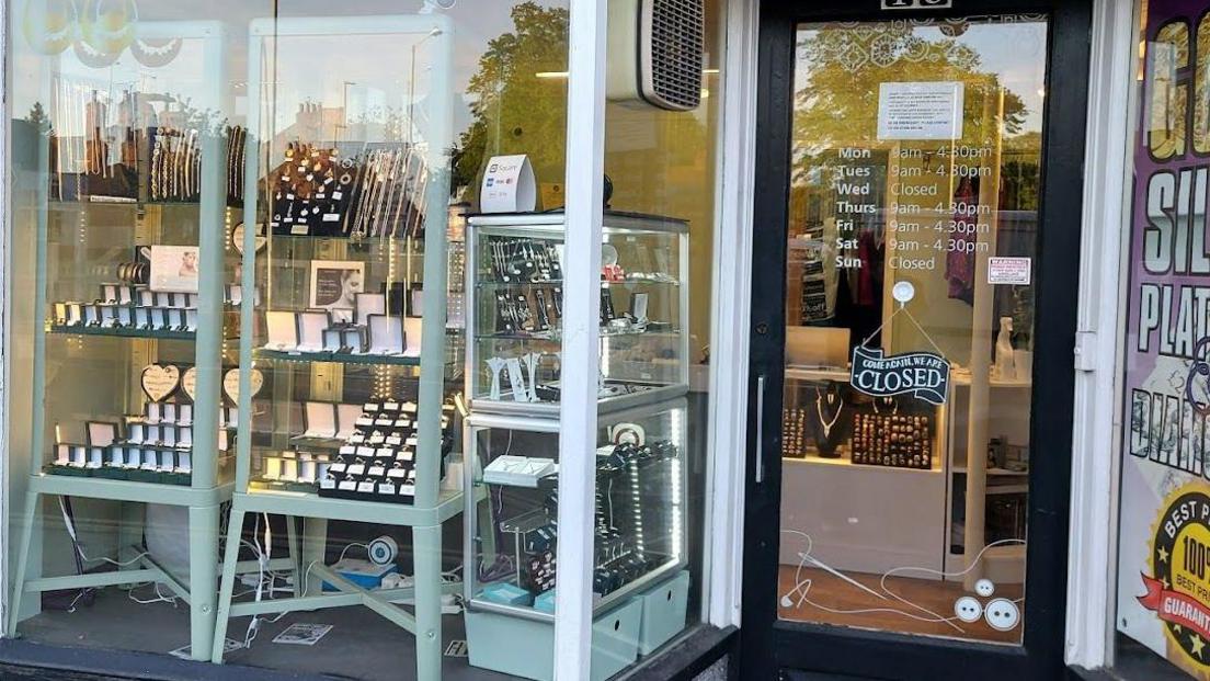 The storefront of Estcourt Jewellers. There are large windows showing displays of rings, necklaces, bracelets and earrings.