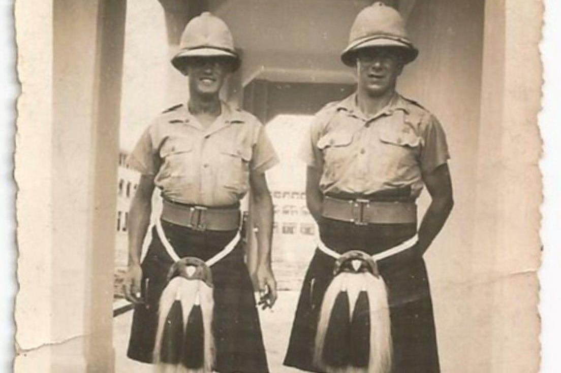 A black and white photo of two men in highland military dress