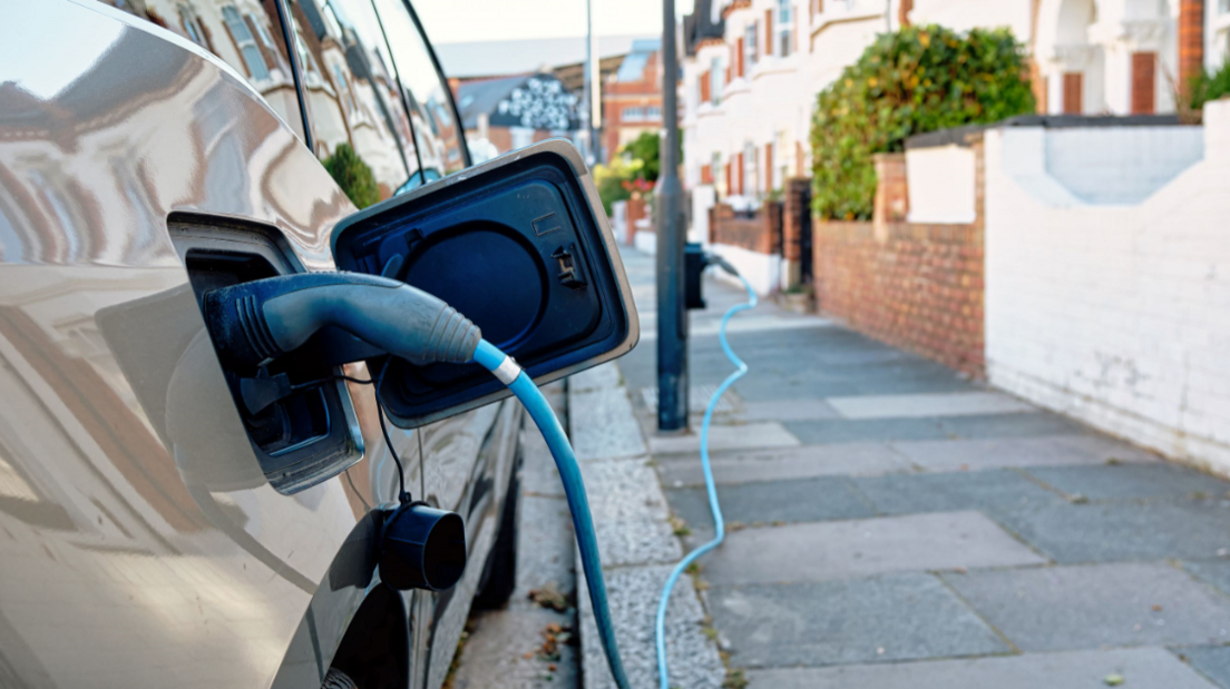 An EV being charged by the side of the road 