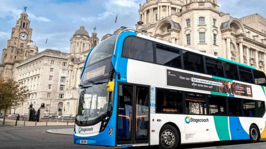 A Stagecoach bus parked up on a road near the Liverpool Liver Buildings 