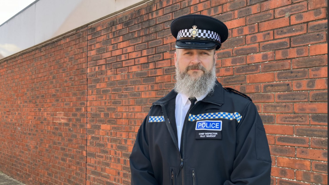 Ch Insp Ollie Warsop in a black police jacket and cap 