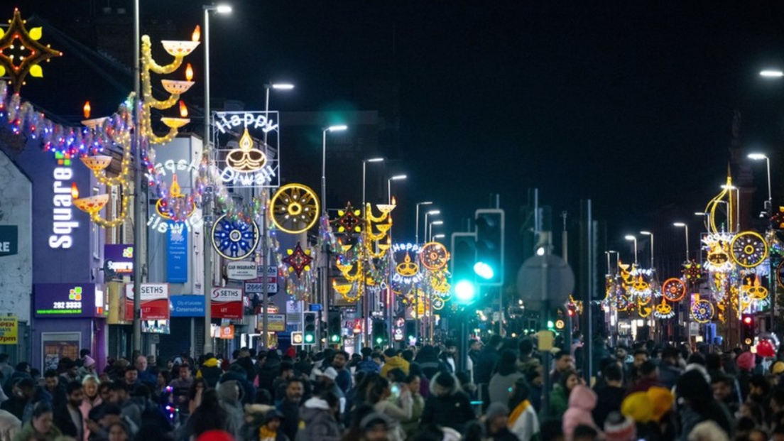 Crowds in Belgrave Road illuminated by Diwali lights