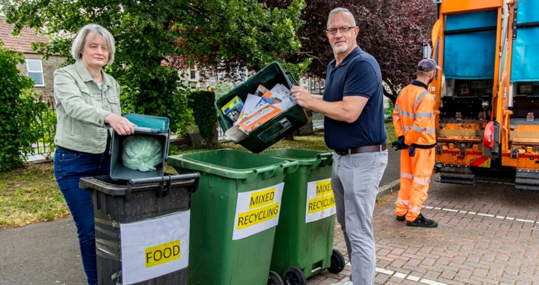 People emptying their rubbish into recycling bins