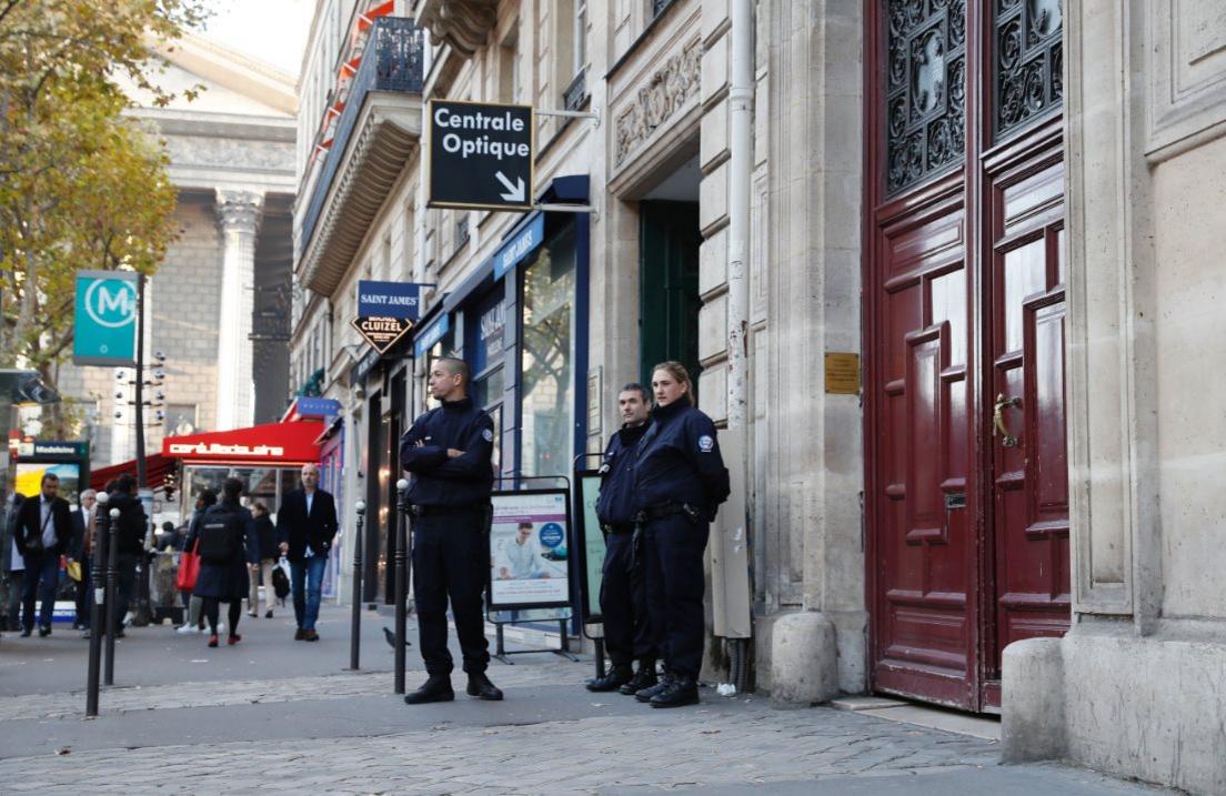 Police stand guard outside the door leading to the luxury apartment where Kim Kardashian was robbed