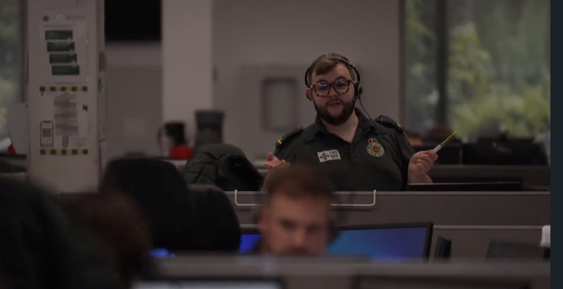 A man in a control centre talks on the phone
