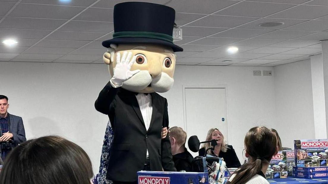 Mr Monopoly statue- wearing a black suit with white shirt and a black top hat 