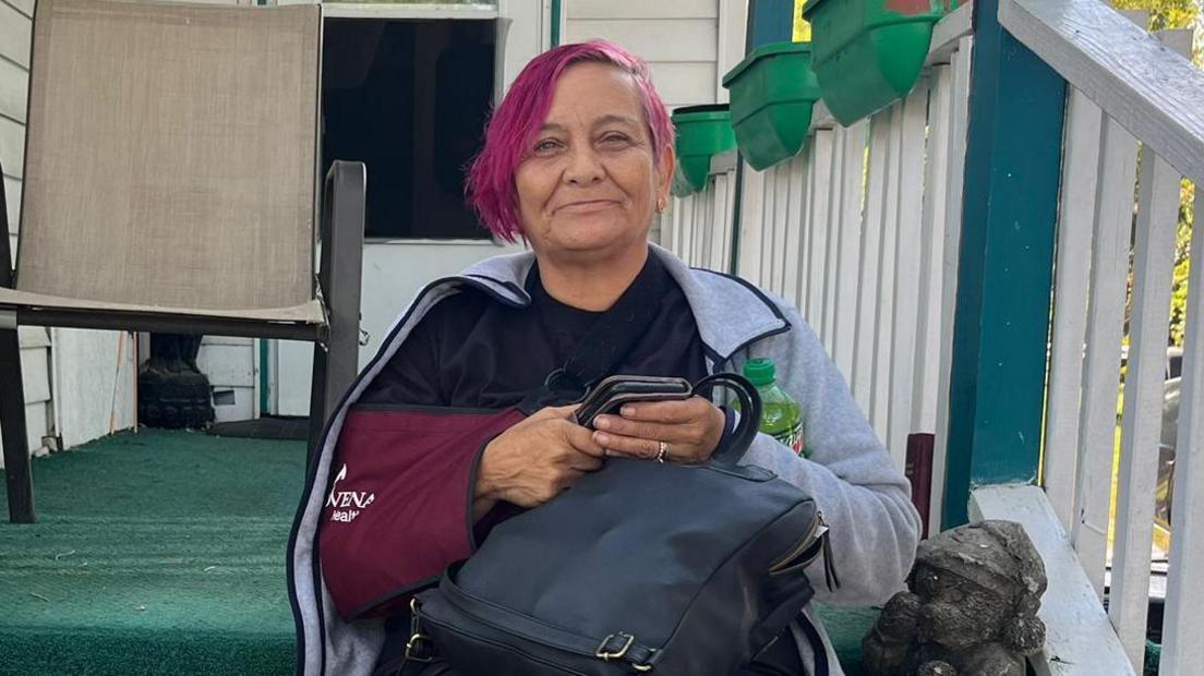 Rachel Oviedo, 57, sits on her porch