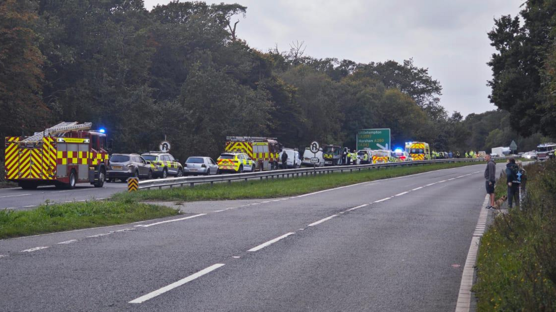 Traffic on the A27 near the scene of the collision with fire engines, police cars and ambulances present