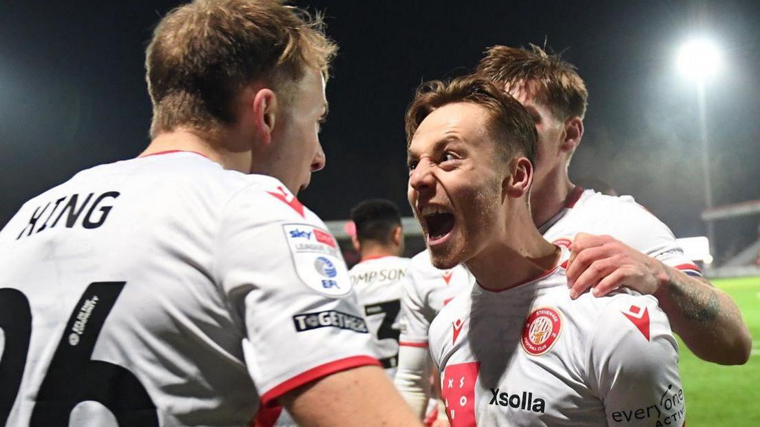 Dan Kemp celebrates with Stevenage team-mate Eli King