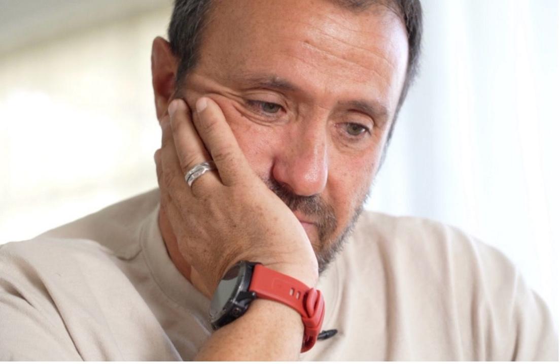 Avi Harush, father of killed soldier Reef, rests his chin on his hand