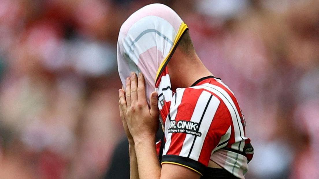 Sheffield United's Harrison Burrows pulls his shirt over his head after the play-off defeat to Sunderland