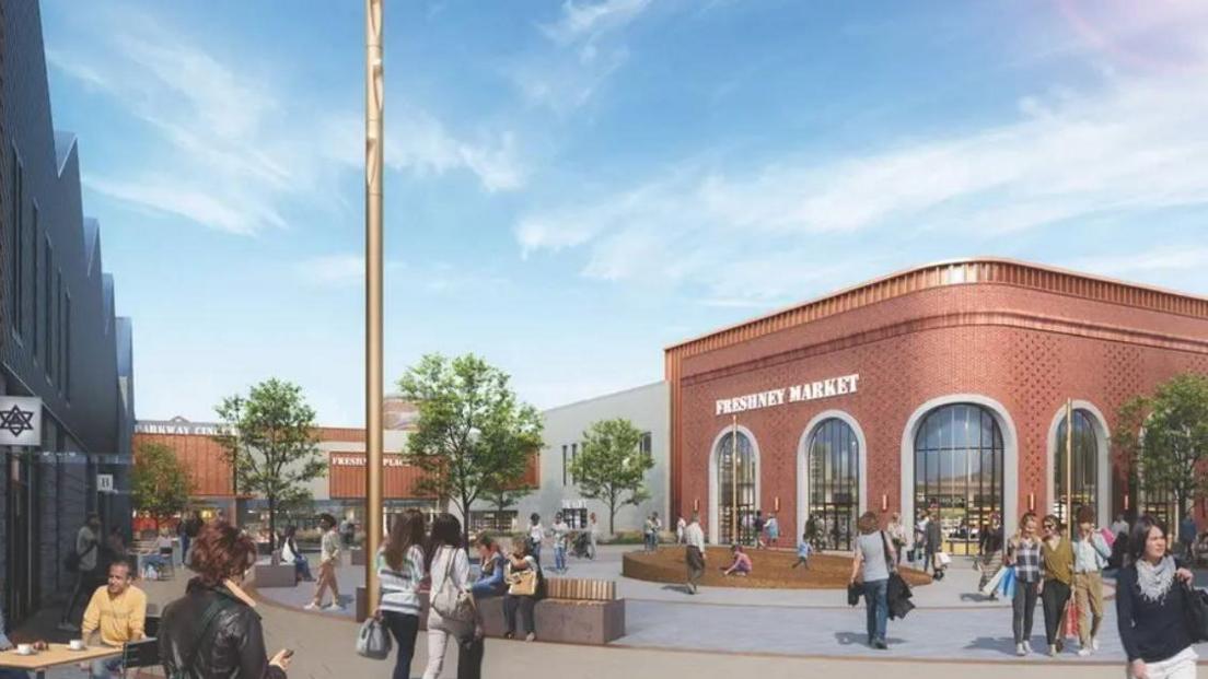 This image is a digital image of a modern shopping and social hub. It shows Freshney Market, a red-brick building with large arched windows. The area is filled with people walking, chatting, and sitting at outdoor cafés. Trees, benches, and a golden pole enhance the open plaza feature. 