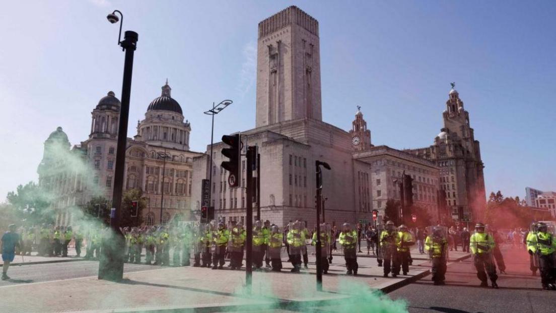 Green coloured smoke rising near a police cordon in Liverpool