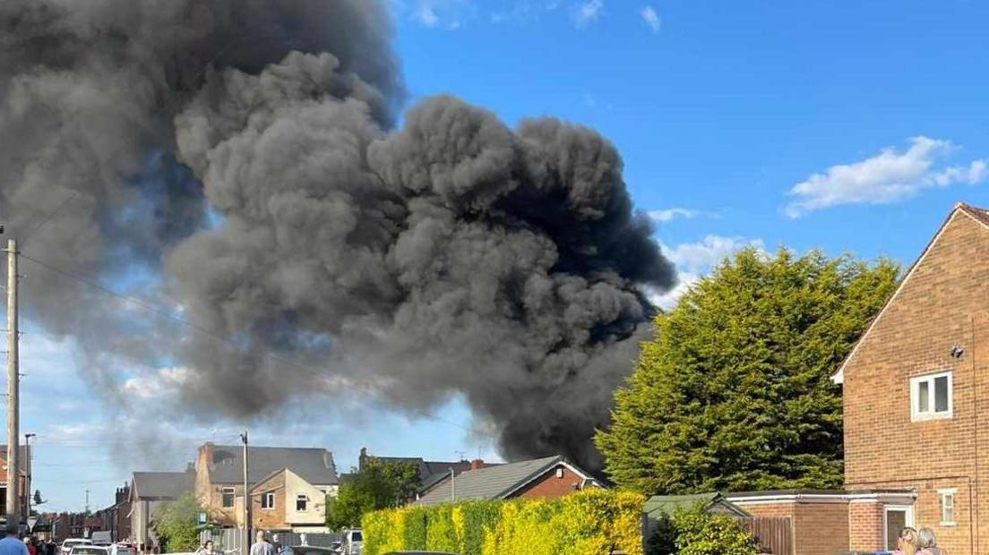 Black smoke rises from a property in Derby