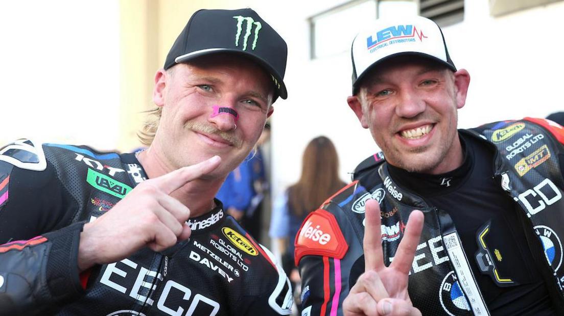 Davey Todd and Peter Hickman make hand gestures while posing for a photo