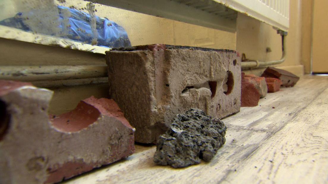 Bricks and stones places on the ground inside a home