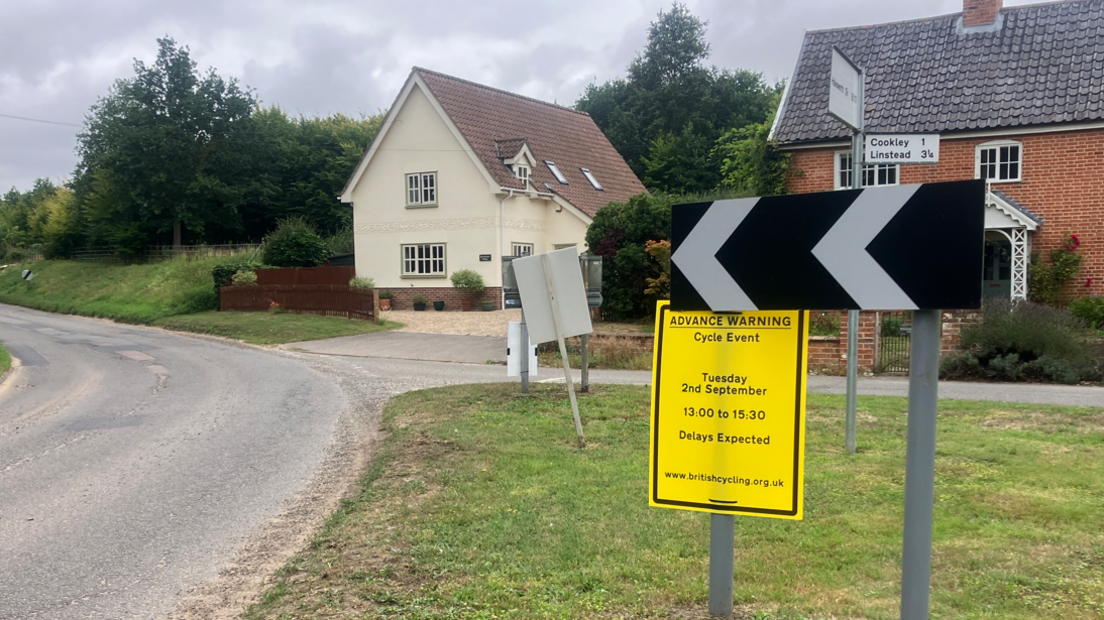 A yellow sign attached to a road sign warning residents and motorists of a forthcoming road closure.