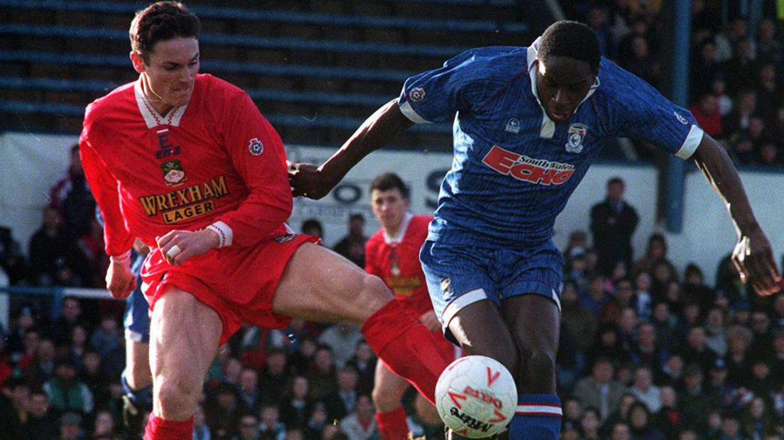 Wrexham's Barry Jones (left) battles for the ball with Cohen Griffith of Cardiff City at Ninian Park in 1994