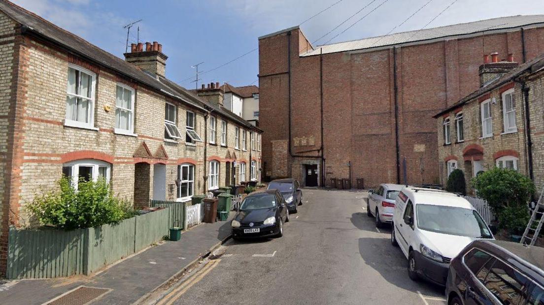 A view of Lower Paxton Road with the back of The Odyssey cinema towering above the terraced houses at the end of the road.