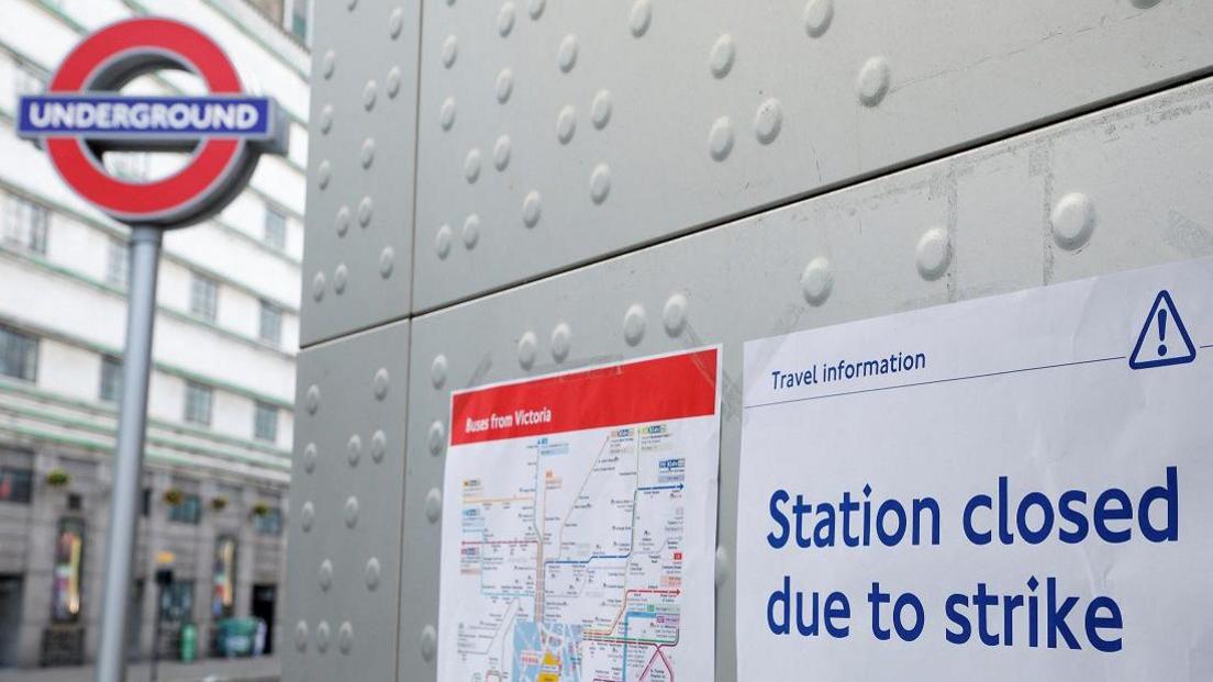 A sign with the words 'Station closed due to strike' at a London Underground station.