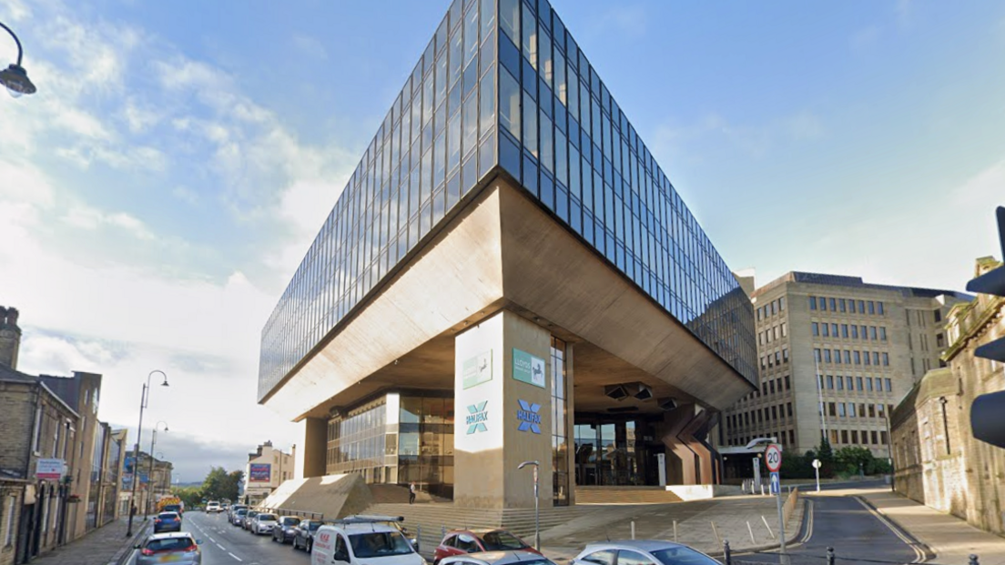  a large square stone and glass building