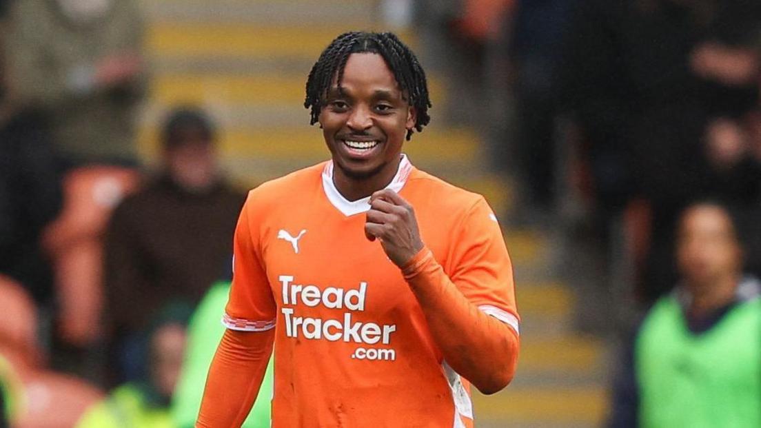 Niall Ennis with a clenched fist after scoring for Blackpool last season