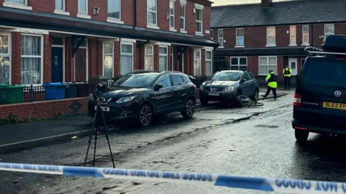 Police tape across Great Southern Street in Moss Side