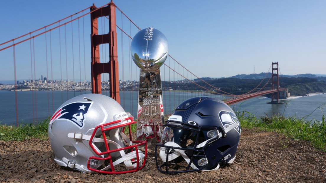 New England Patriots and Seattle Seahawks helmets with a Vince Lombardi Super Bowl trophy shown at the Golden Gate bridge in San Francisco