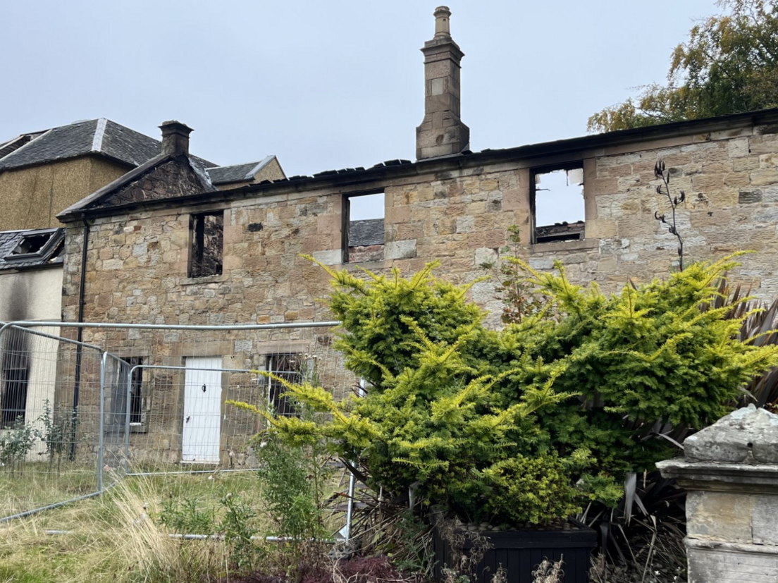 Part of the hotel building with the roof burned off