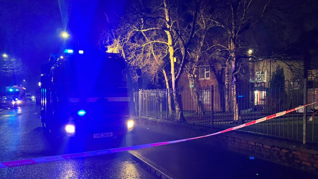 Fire appliance and tape beside railings in Sydenham in east Belfast