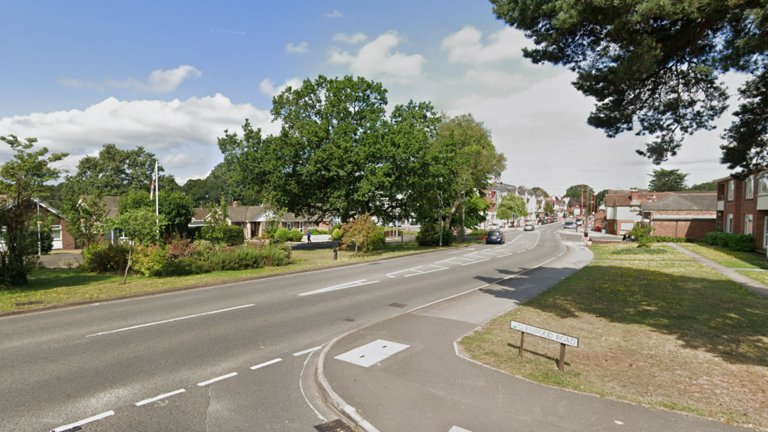 A general view of Station Road at the junction of Glenwood Road. The picture shows a sunny day with leaves on trees that line the road in a residential area  