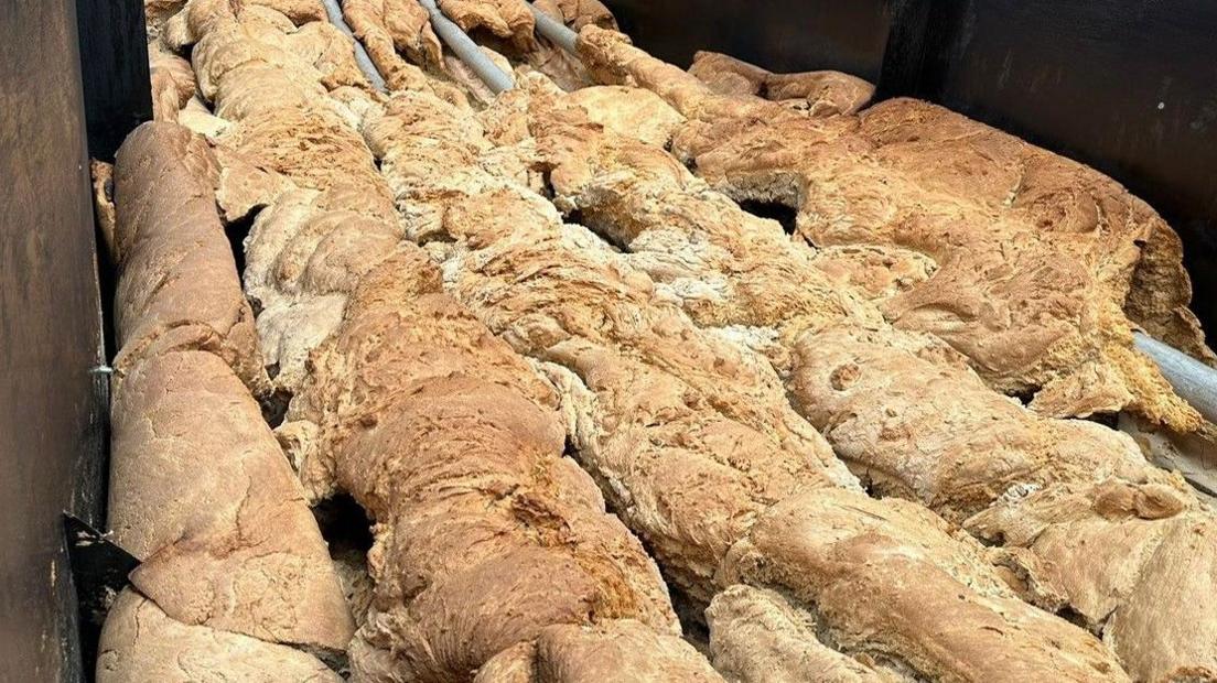 The two-ton loaf of bread laid out in a container