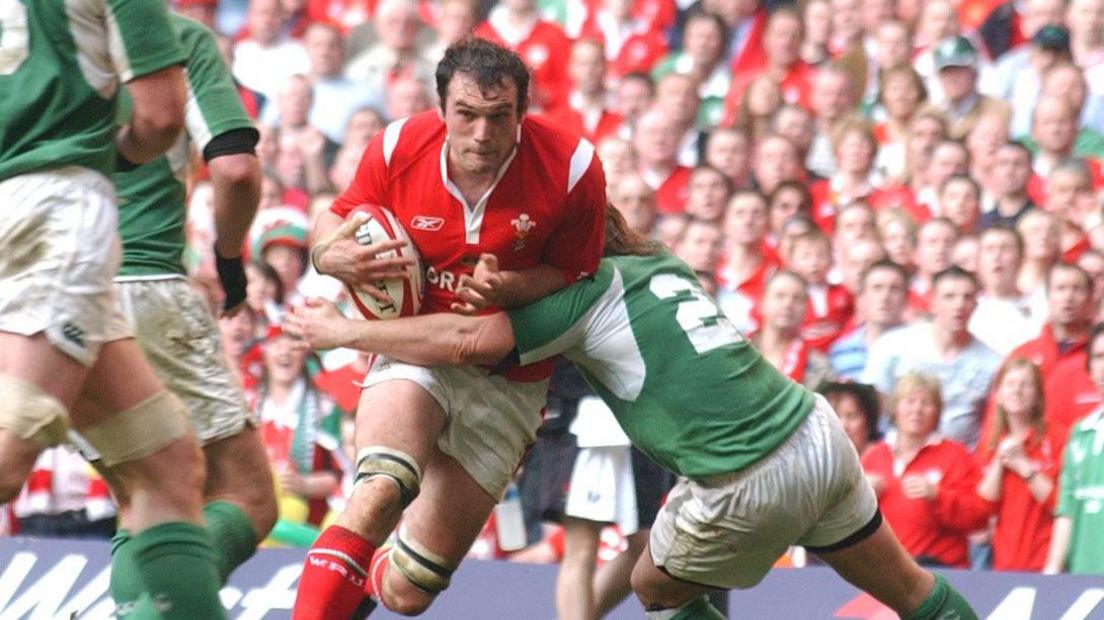 Robert Sidoli is tackled by an Ireland player