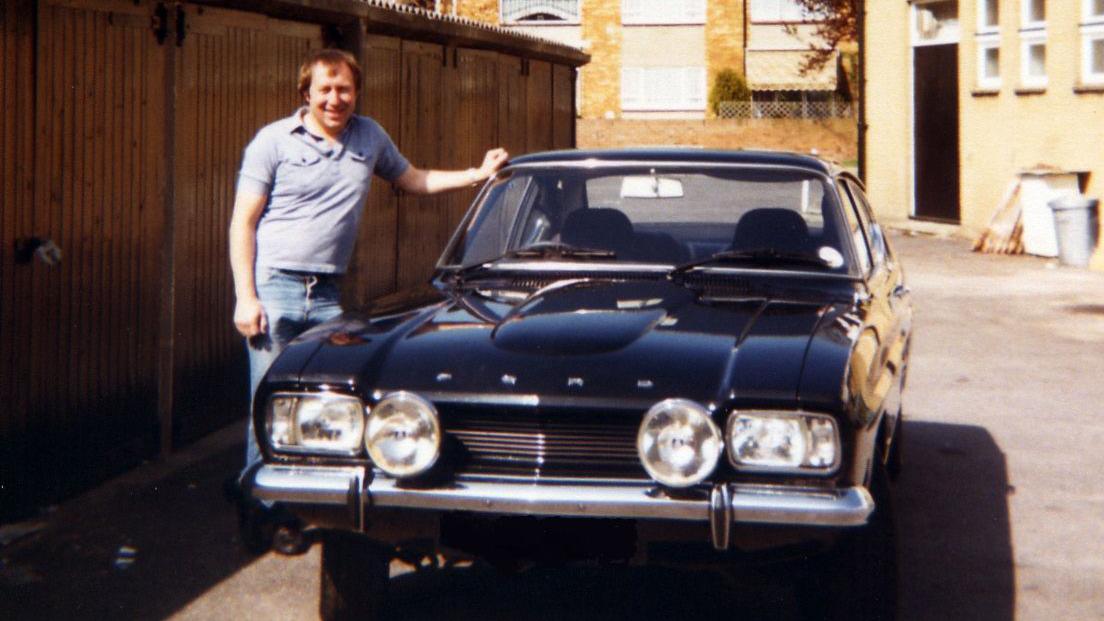 David Doyle with longer hair stood next to his Capri in 1982.