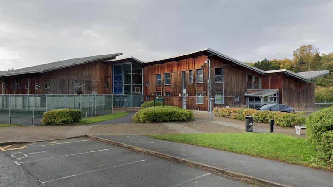 Warrington Peace Centre  - a two storey building with car parking space in front