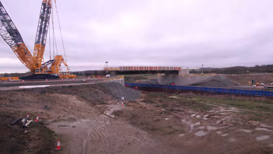 The bridge structure in place with a crane to the left