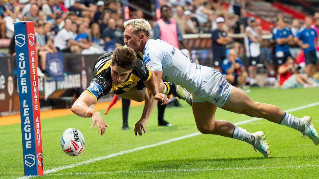 York Knights' Jon Bennison is caught by a try-saving tackle by Toulouse's Olly Ashall-Bott