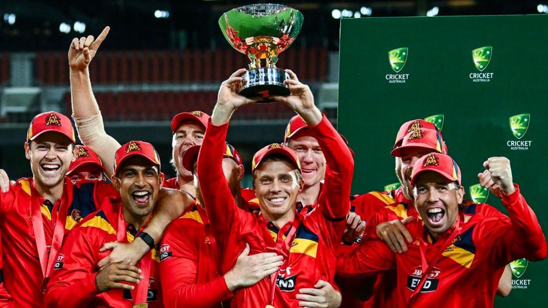 Nathan McSweeney (centre) holding the Dean Jones Trophy 