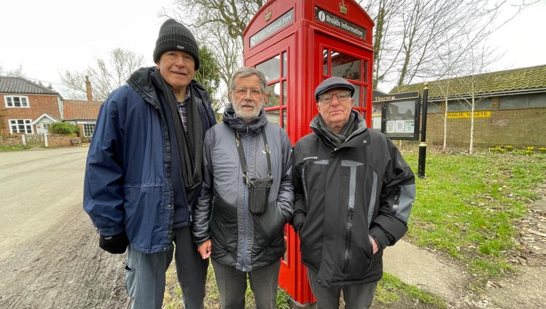 John Pond David Sturdy and John Wallace, standing outside a red phonebox in Thurne, Norfolk