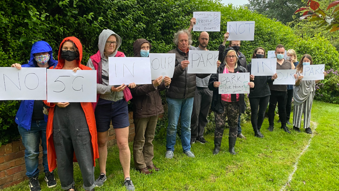 Hove Park residents holding up signs protesting the plans