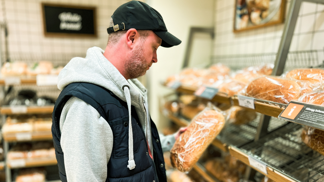 Man looks at loaf of bread 