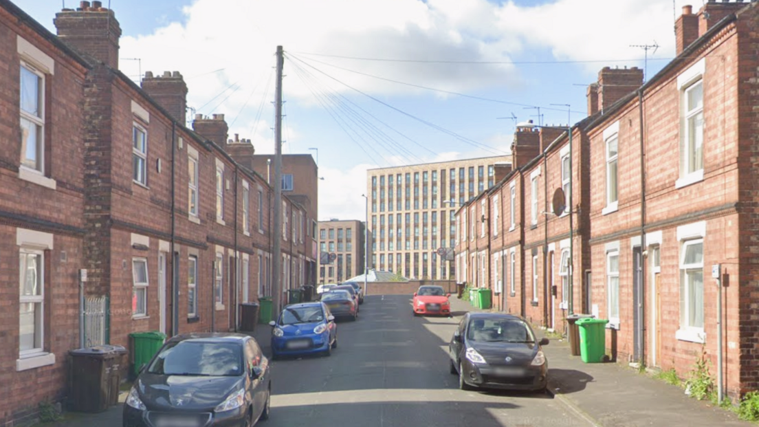 A residential street near the city centre with a high-rise building visible at the end