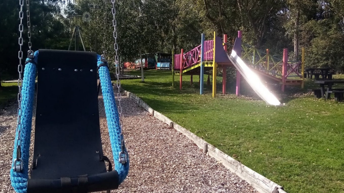 Part of TVAP, including a playground and a slide on the right side of the picture, along with a seat swing. 