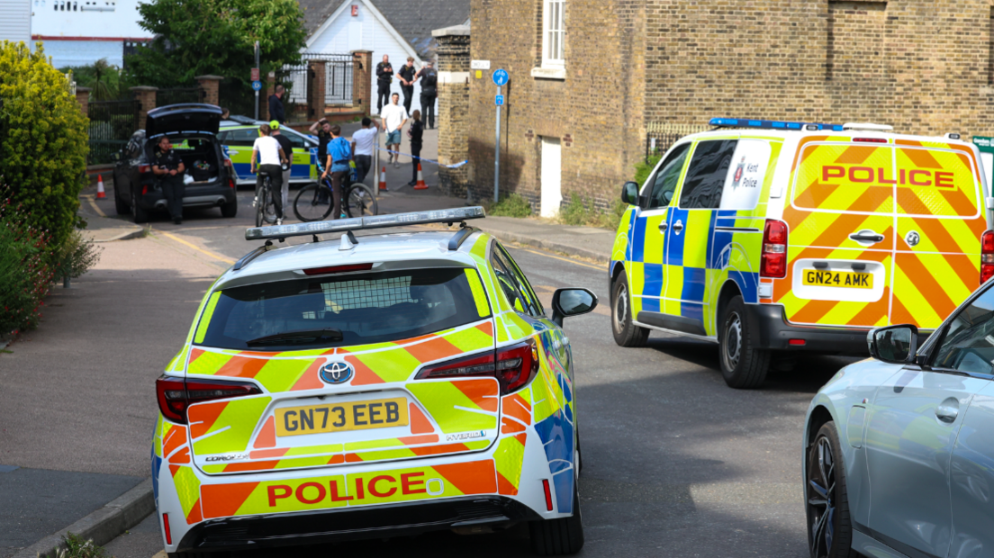 Two police cars on a street in Gravesend.