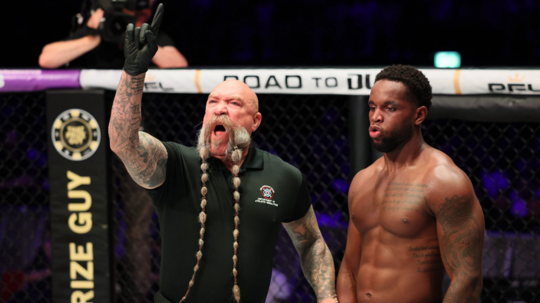 Mike Beltran holds his finger up showing a point deduction for Donegi Abena