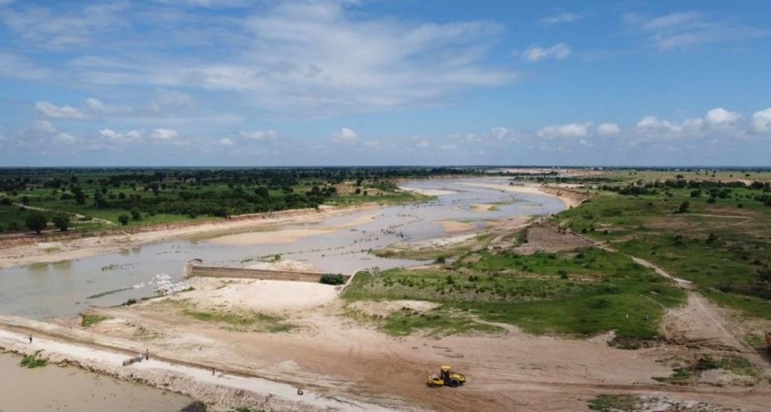 Landscape of a vast and remote place, where there are ruins of where the dam used to be.