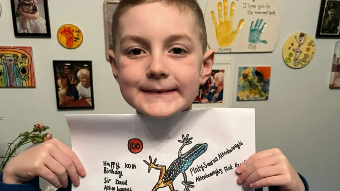 Max showing his 100th drawing of a platysaurus attenboroughi, also known as Attenborough's flat lizard. 