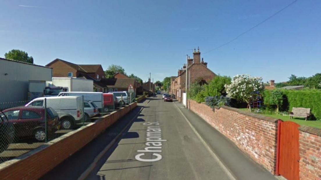 A Google Street View capture of Chapman Street in Market Rasen, a quiet residential street with terraced houses on the right and a petrol station and car forecourt to the left.