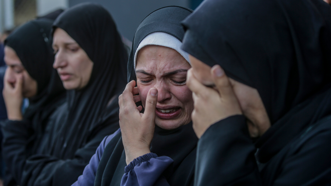 Palestinian women mourn members of a family killed in an Israeli airstrike at Al Aqsa Martyrs Hospital in Deir Al Balah town, central Gaza Strip, on 15 January 2024.