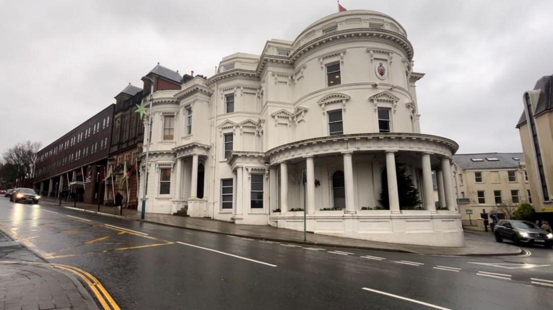 The Isle of Man's parliamentary buildings. Known as the Wedding Cake building, it is a round, white, three-tiered building.